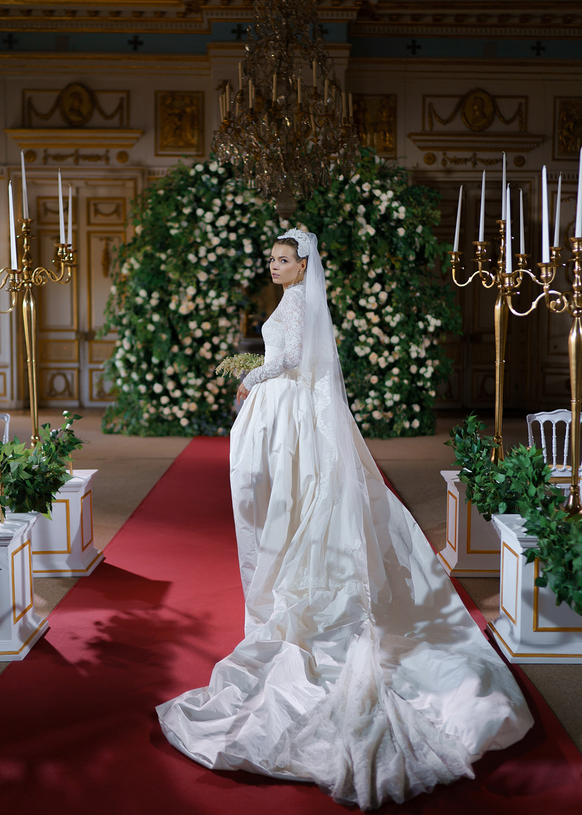 Grace Kelly inspired bride poses on red carpet aisle