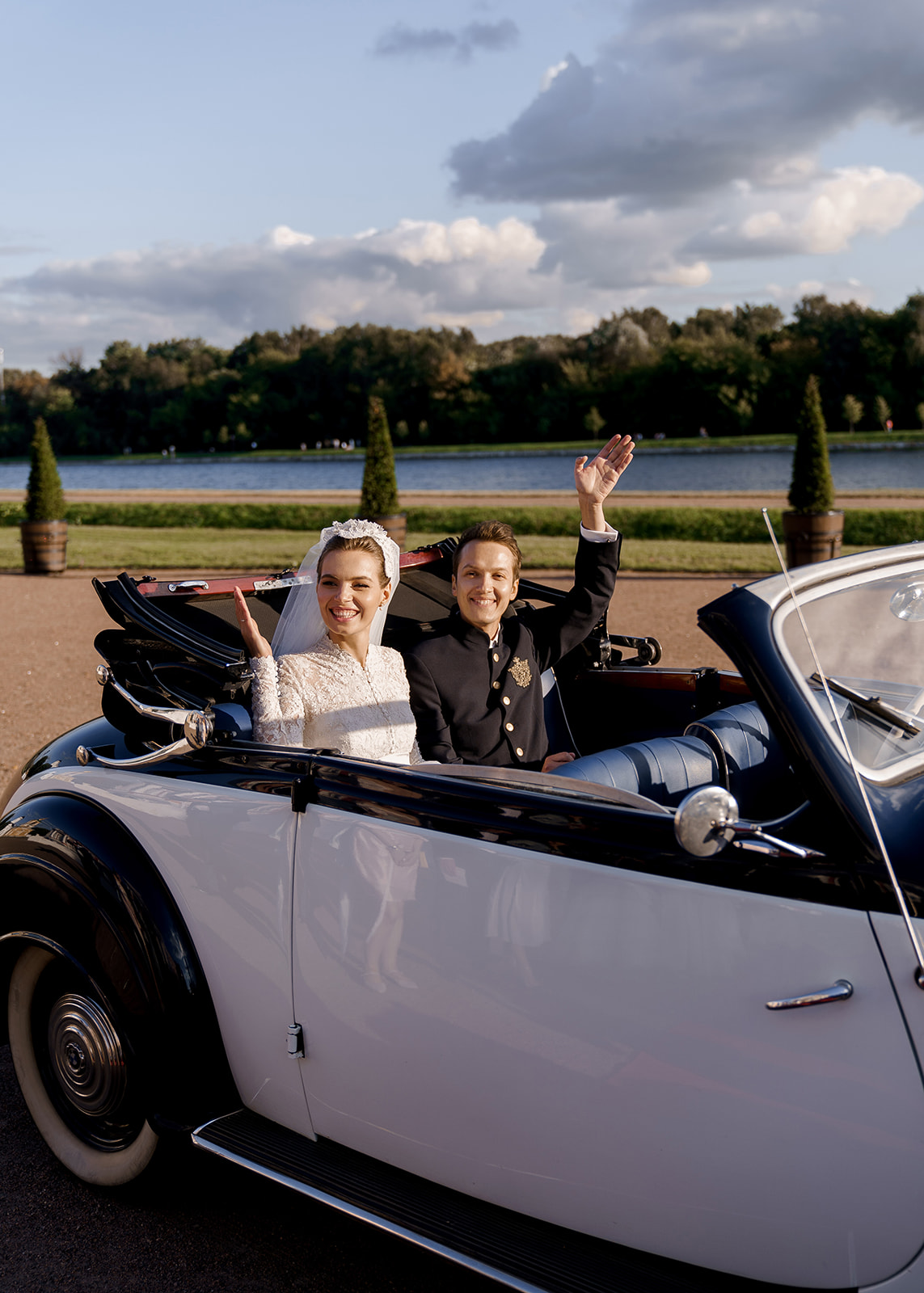 royal wedding bride and groom wave from vintage Rolls Royce